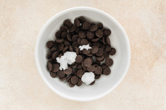 Chocolate chips and coconut oil in a bowl.