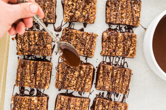 Squares dipped in chocolate and then drizzled over with a spoon.