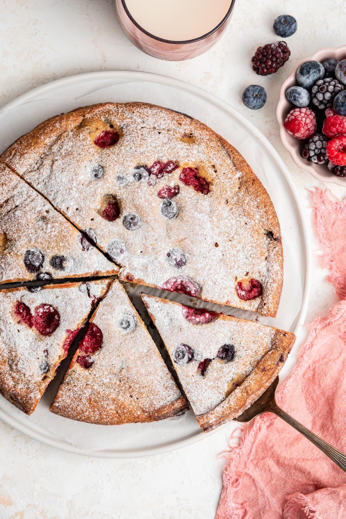 An easy berry cake cut into slices.