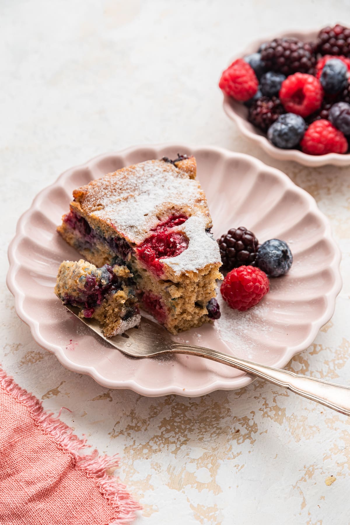 A slice of easy berry cake on a plate.