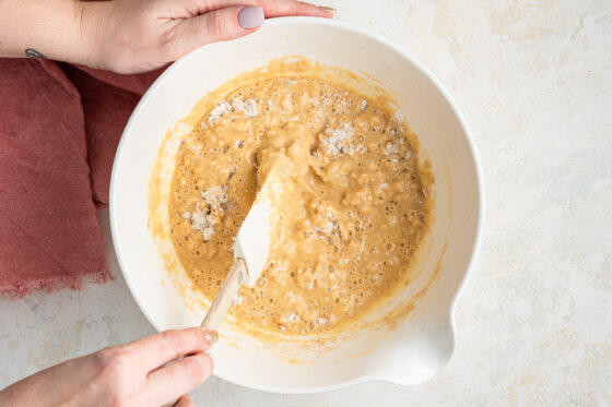 Mixing the dry and wet ingredients together.