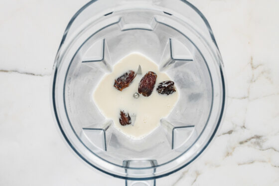 Almond milk and dates in a high powered blender.