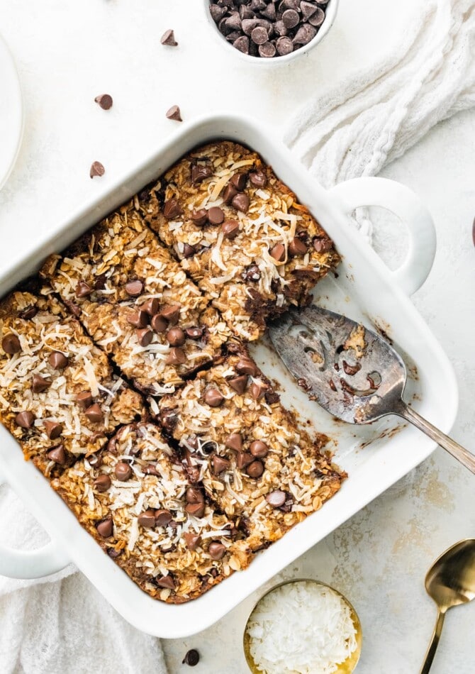 A baking dish containing lactation baked oatmeal cut into 6 servings, one serving is missing.