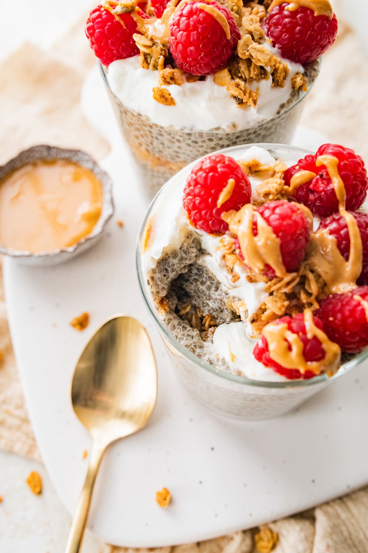 A jar of protein chia pudding with a bite removed.