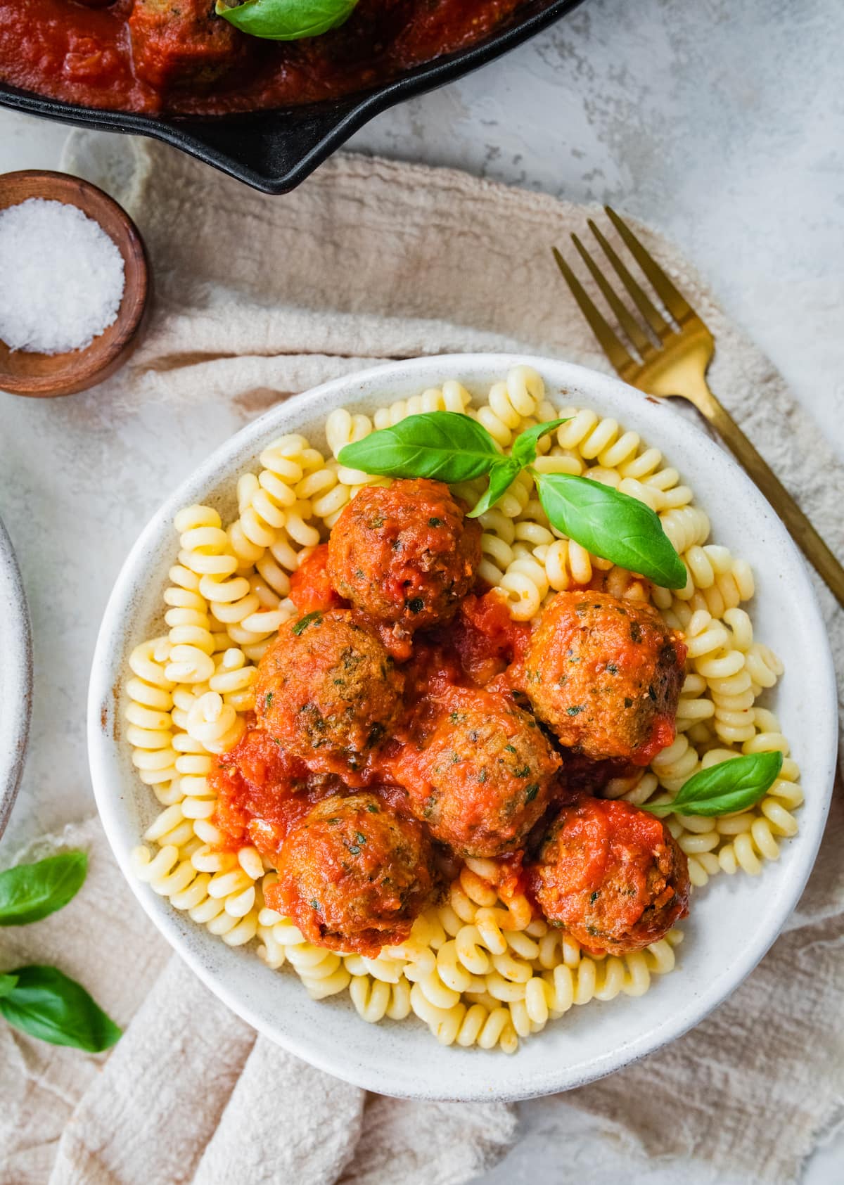 Spinach turkey meatballs served over pasta.