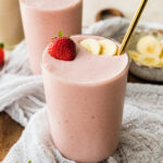 A strawberry banana protein smoothie in a glass.