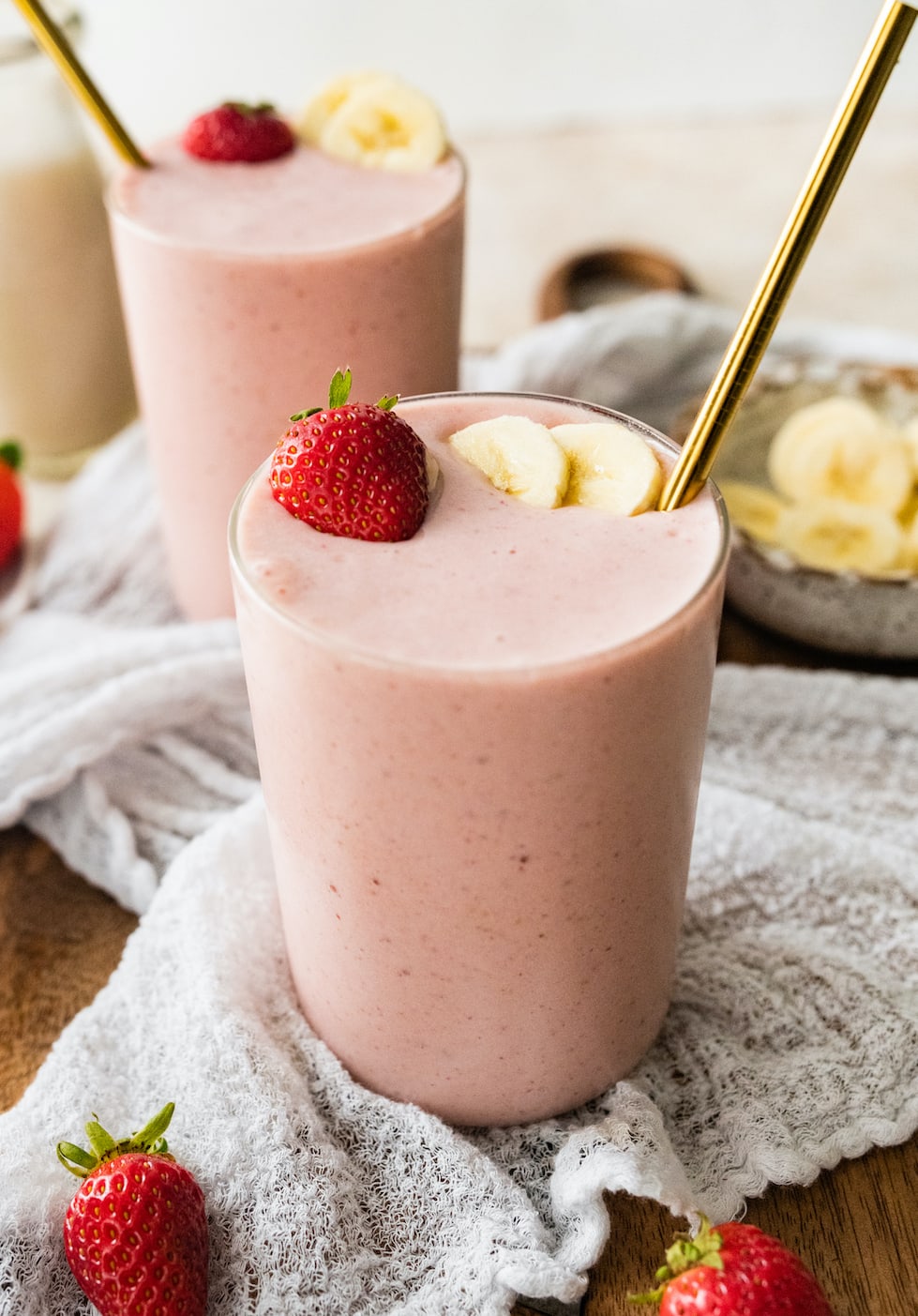 A strawberry banana protein smoothie in a glass.