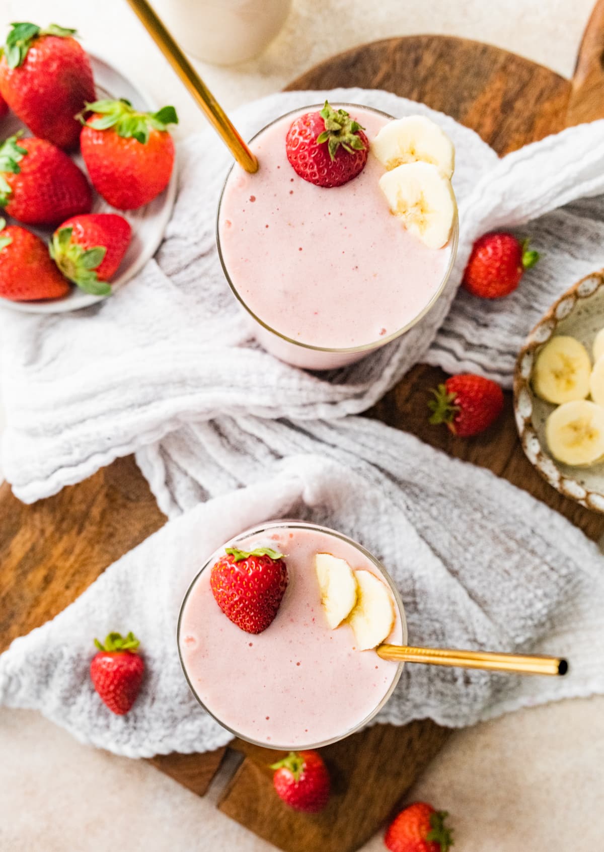 Two strawberry banana protein smoothies.
