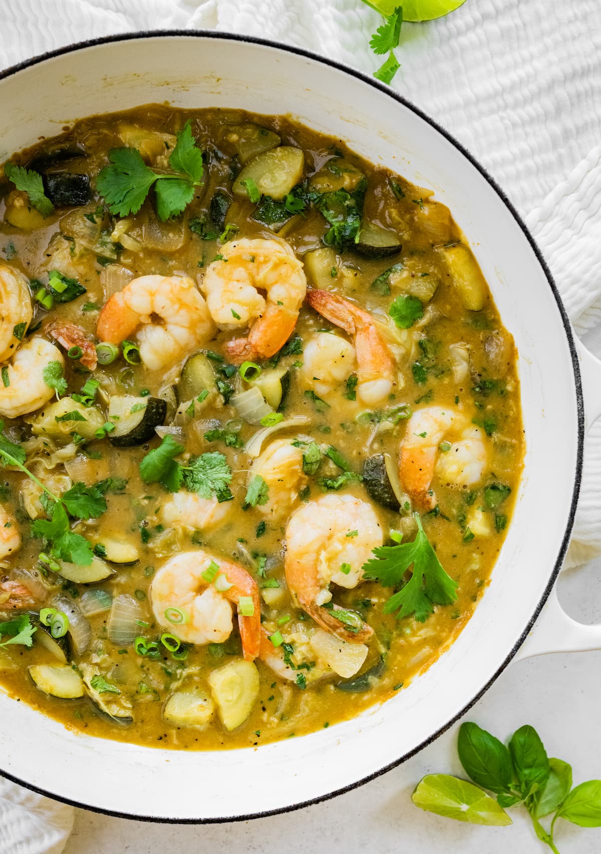 A pot full of thai green curry with shrimp.