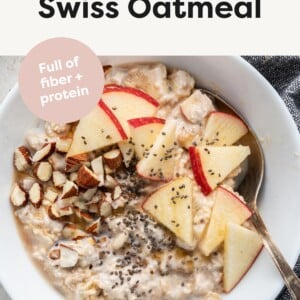 Bowl of chilled swiss oatmeal topped with nuts, apples and seeds.