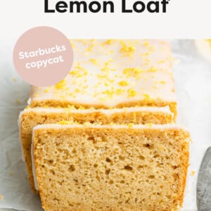 A lemon loaf topped with a lemon glaze and lemon zest. The loaf is cut so you can see the inside of the loaf.