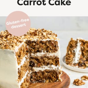 3-layer oatmeal carrot cake, frosted with chopped walnuts on top served on a wooden board. A few slices of the cake have been cut out exposing the inside of the cake.