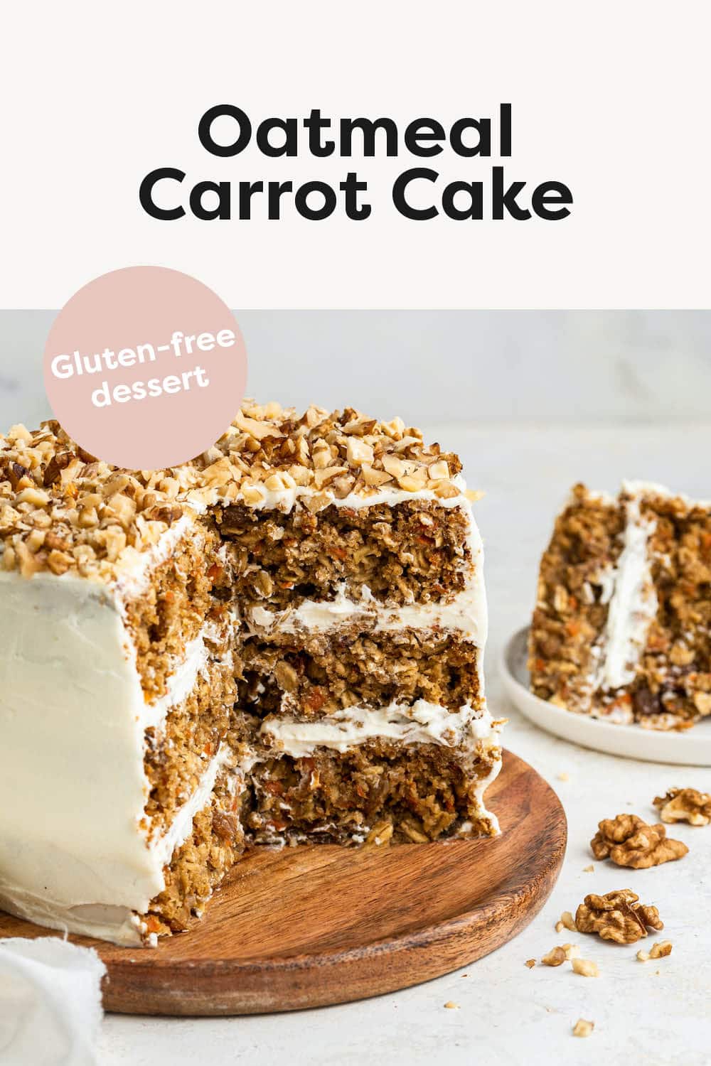 3-layer oatmeal carrot cake, frosted with chopped walnuts on top served on a wooden board. A few slices of the cake have been cut out exposing the inside of the cake.
