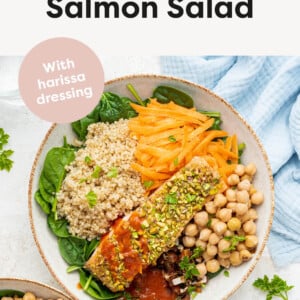 Pistachio salmon salad topped with quinoa, carrots, chickpeas, dates and harissa dressing.