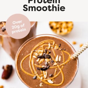 Snickers smoothie topped with peanut butter, peanuts and cacao nibs.