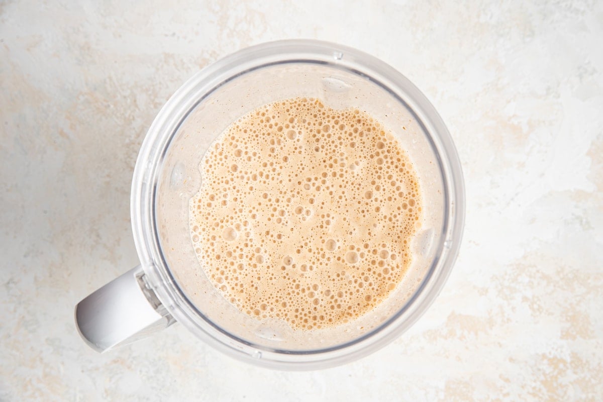 Banana almond butter smoothie blended together in blender.