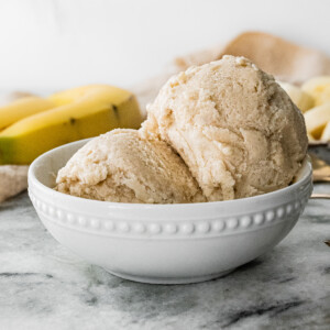 White bowl with two scoops of banana frozen yogurt.