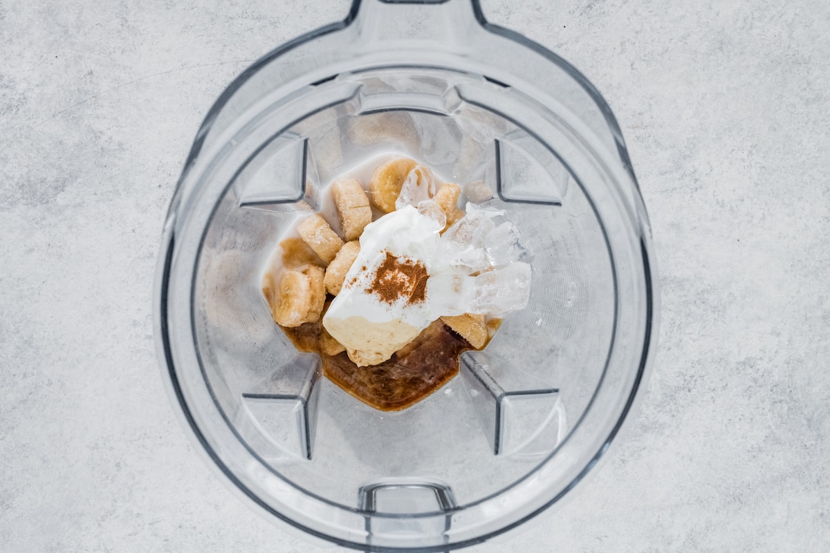 Banana smoothie ingredients in a blender.