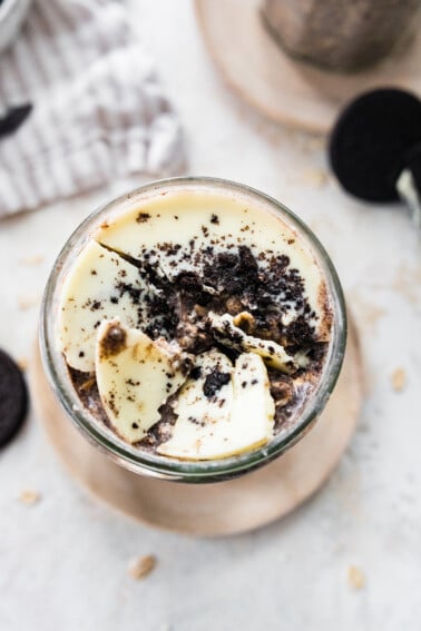 Cookies and cream overnight oats with broken white chocolate magic shell topping.