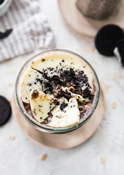 Cookies and cream overnight oats with broken white chocolate magic shell topping.