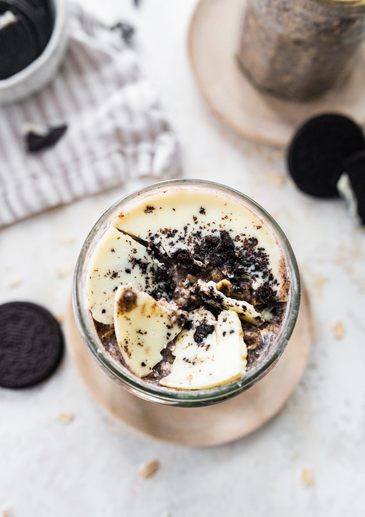 Cookies and cream overnight oats with broken white chocolate magic shell topping.