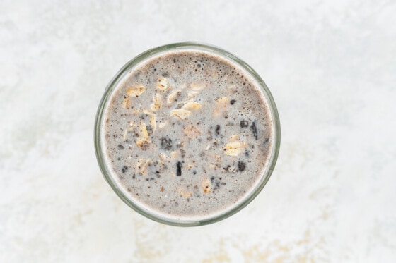 Cookies and cream overnight oats ingredients just combined in mason jar.