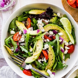 Deconstructed guacamole salad with a fork.