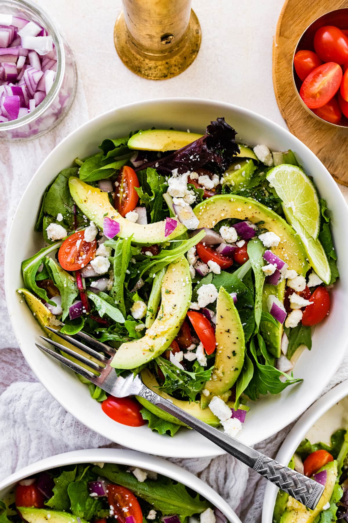 Deconstructed guacamole salad with a fork.