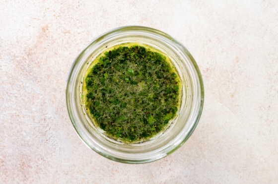 Combined cilantro lime dressing in a mason jar for deconstructed guacamole salad.