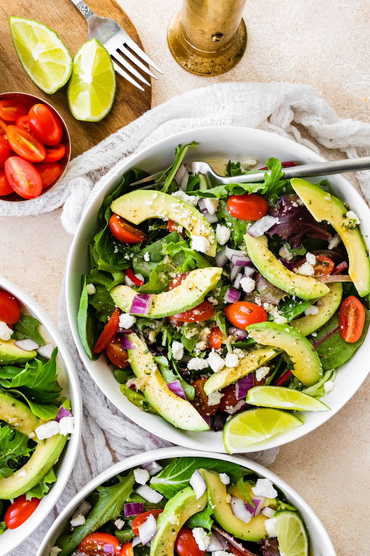 Three bowls of deconstructed guacamole salad.