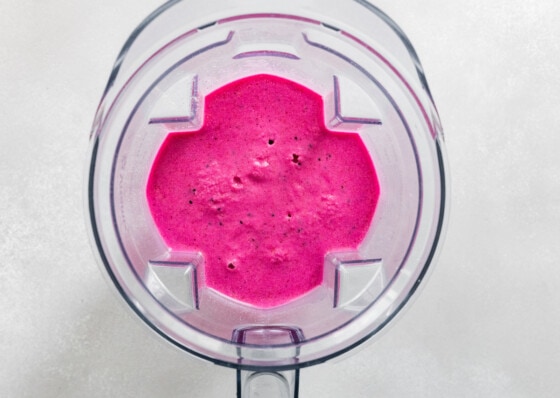 Dragon fruit smoothie blended together in blender.