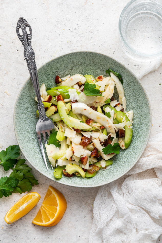 Fennel and Celery Salad with Dates and Shaved Parmesan // A bright and fresh salad that you can add to any meal! Fennel and celery salad in on small bowl with fork.