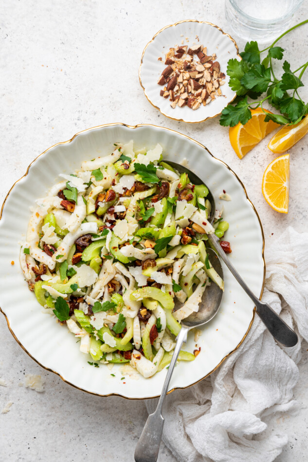 Fennel and celery salad in a serving bowl with two spoons.