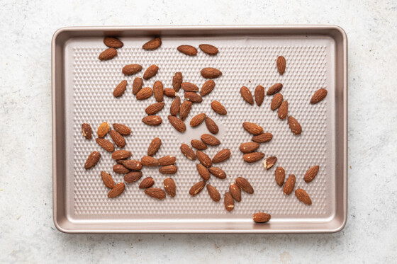 Roasted almonds on a baking tray.