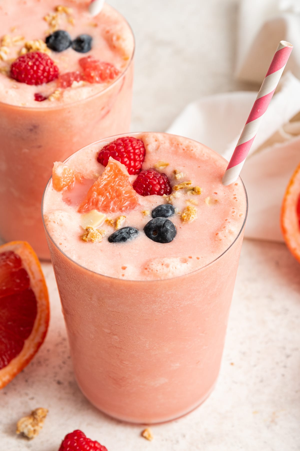 Grapefruit smoothie topped with fresh berries, grapefruit and granola.
