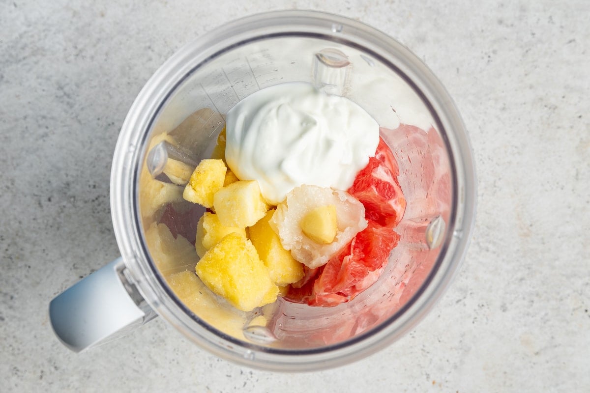 Grapefruit smoothie ingredients in blender.
