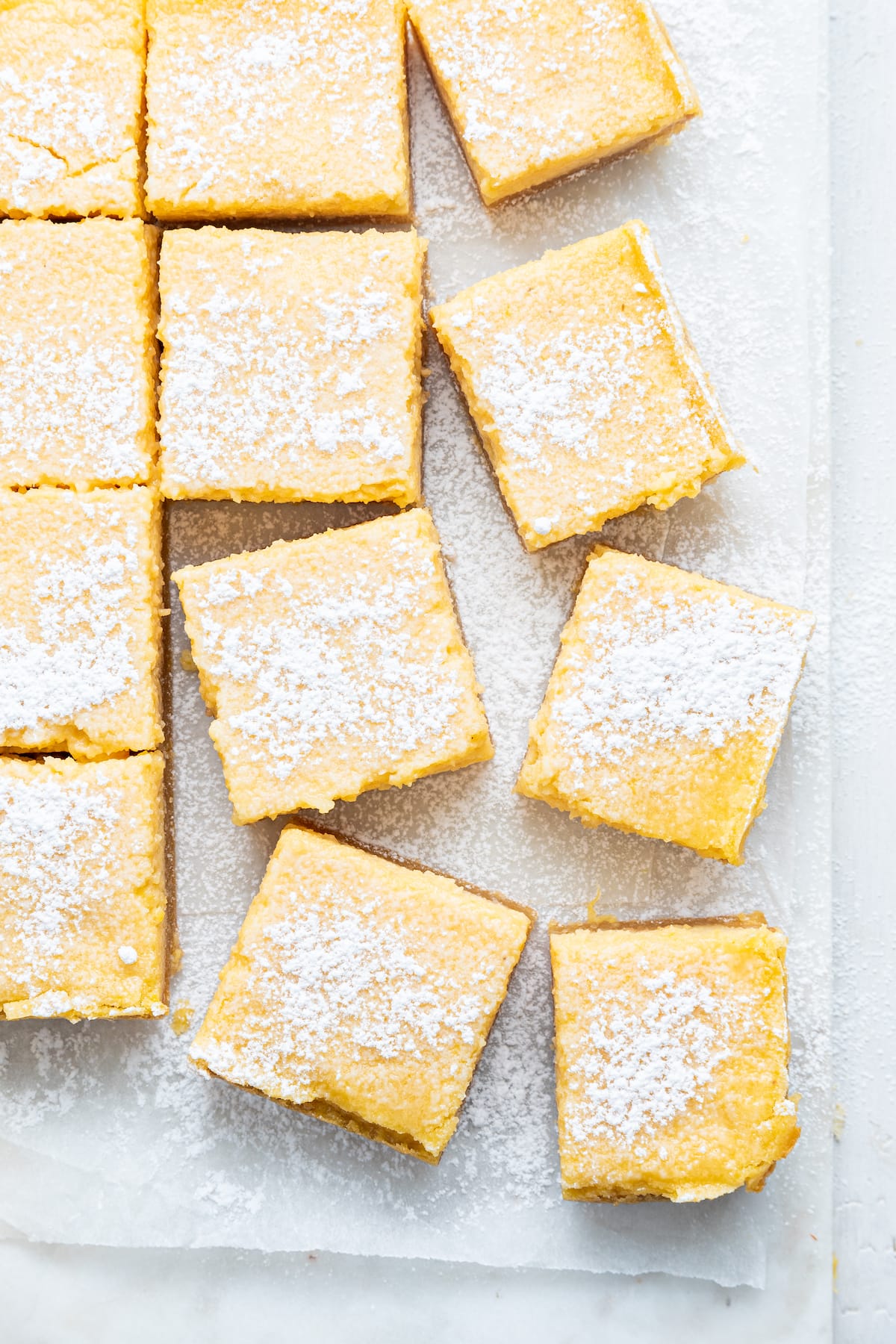 Individual lemon bars angled topped with powdered sugar.