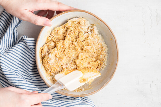 Woman's hands mixing crust for lemon bars.