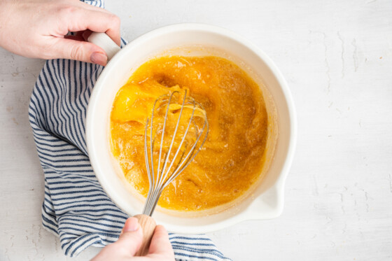 Woman's hands whisking lemon filling.