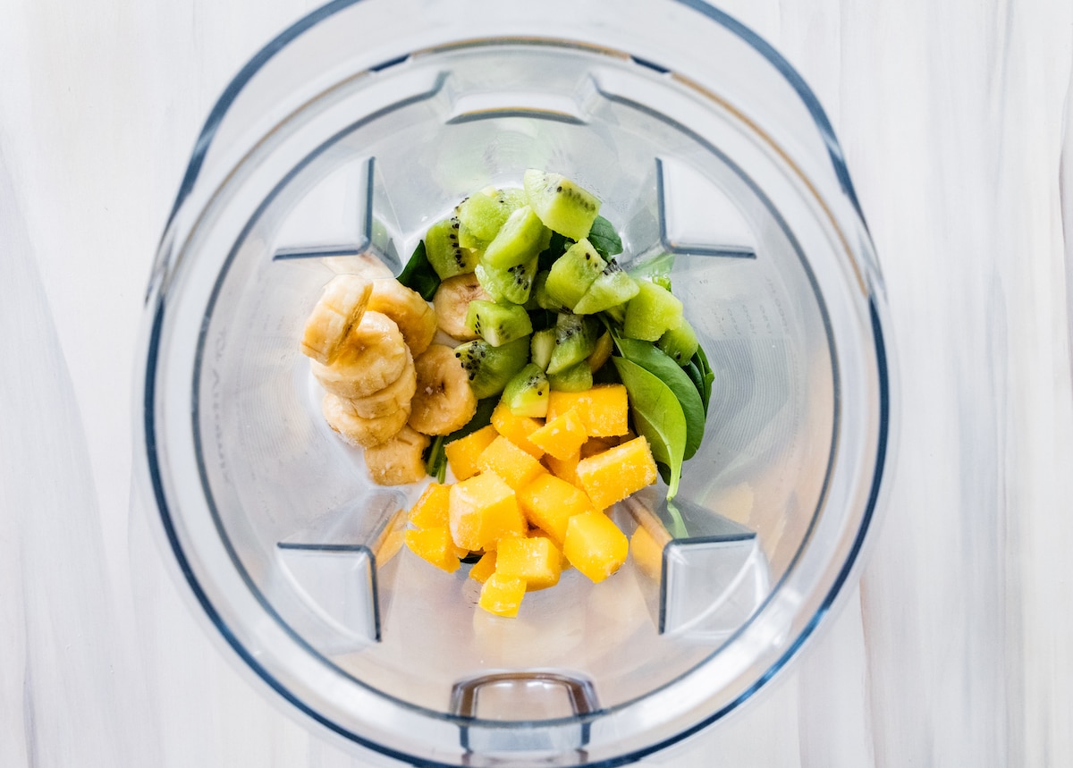 Kiwi smoothie ingredients in blender.