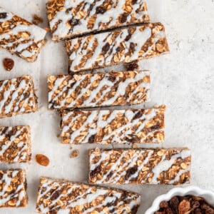 Overhead image of oatmeal raisin protein bars with coconut butter drizzle.