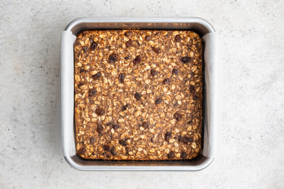 Baked oatmeal raisin protein bars in pan.