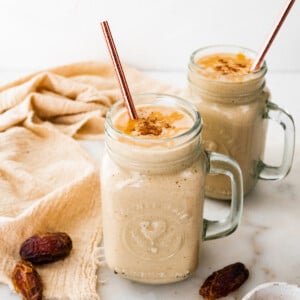 Two tahini smoothies with straws.