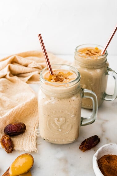 Two tahini smoothies with straws.