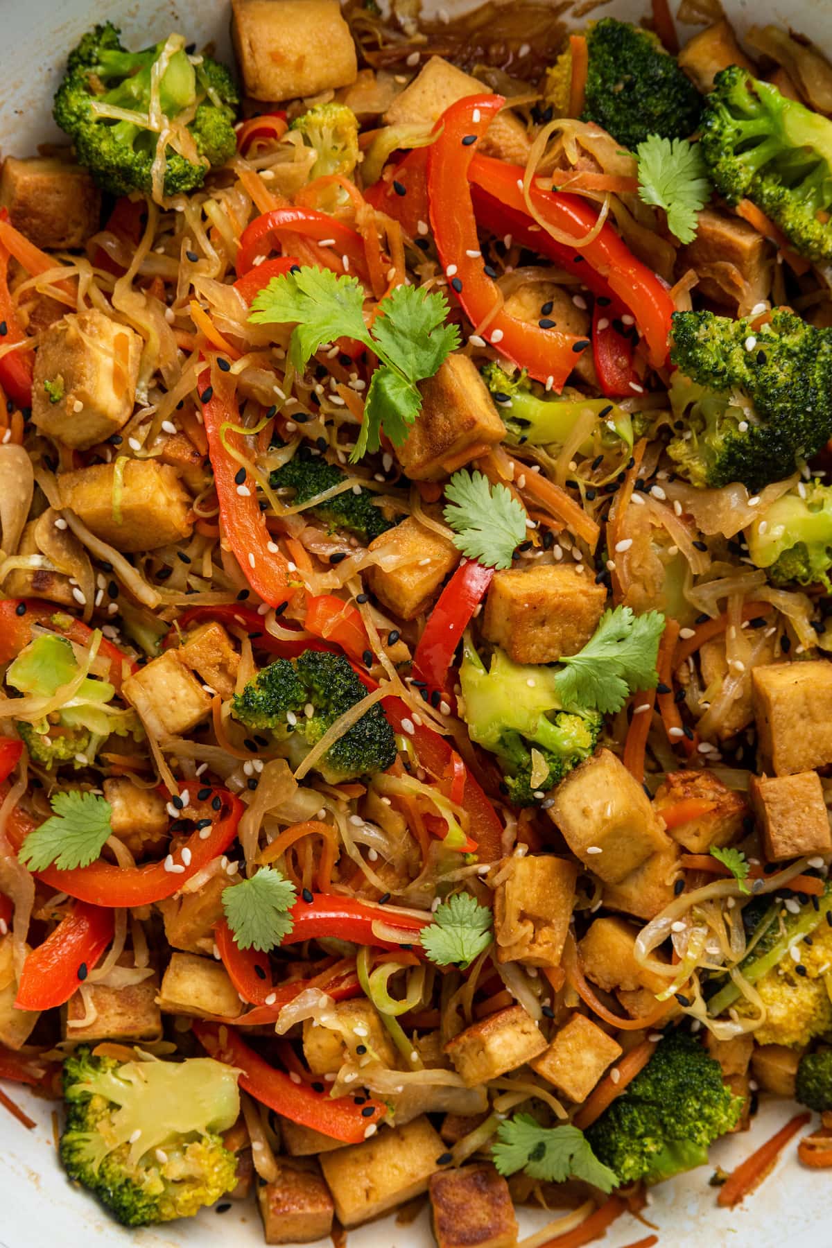 Close up of tofu cabbage noodle bowl in a skillet.