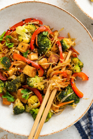 A tofu cabbage noodle bowl in a bowl with chopsticks.