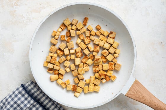 Cooked tofu in a skillet.
