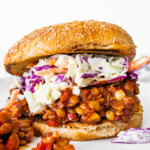 One vegan Sloppy Joe on a whole wheat bun topped with coleslaw.