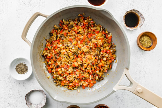 Vegetables sautéing in a skillet for the vegan Sloppy Joes.