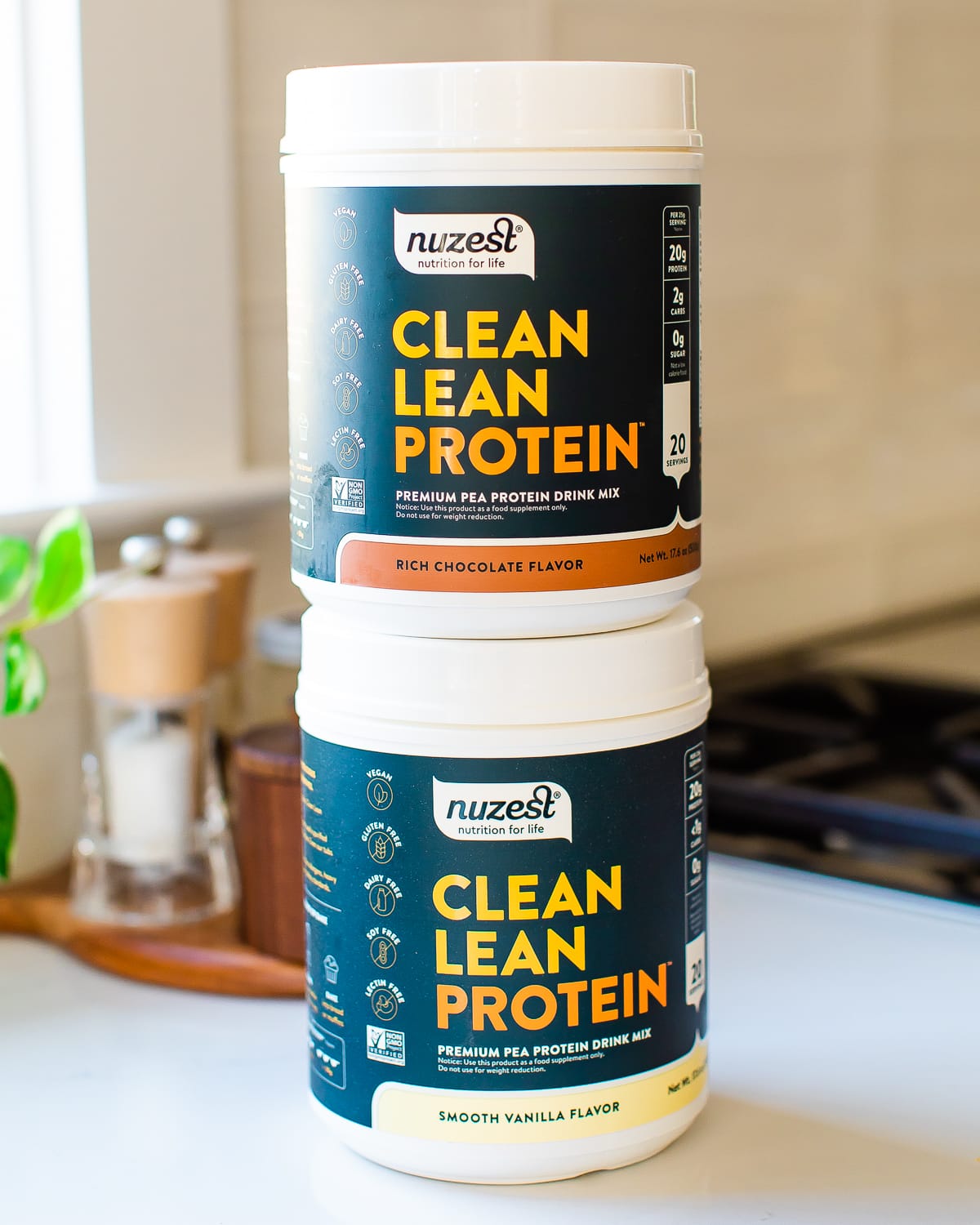 Chocolate and vanilla containers of Nuzest protein powder.